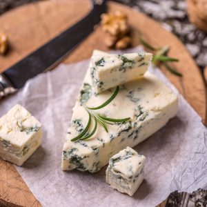 Blue cheese slices on cutting board